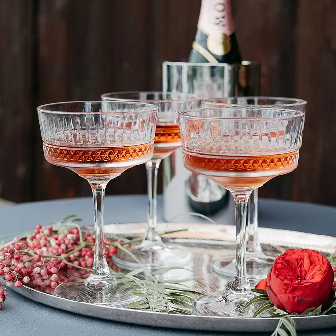 4 mit Champagner gefüllte Gläser für die Hochzeit im kleinen Kreis. Liebevoll dekoriert.
